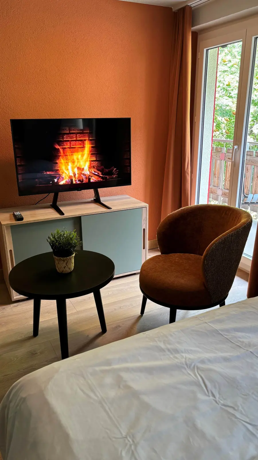 Living room with smart TV and balcony access