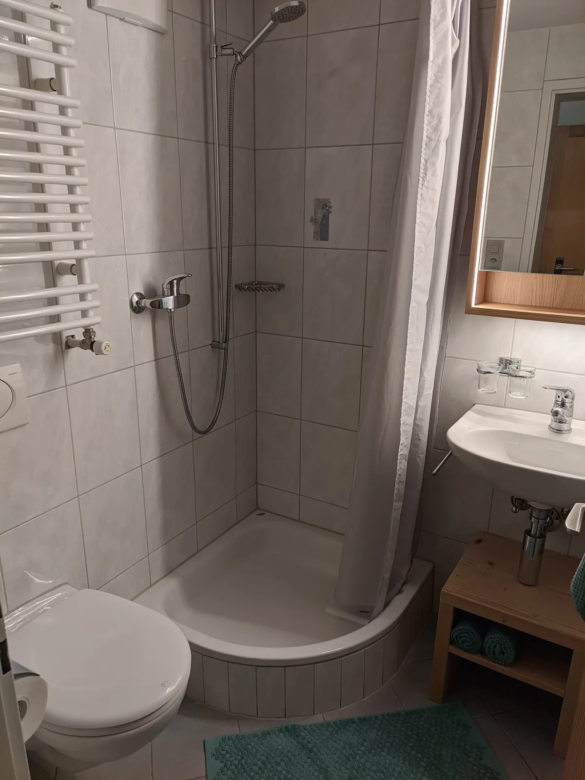 Bathroom with shower and heated towel rail