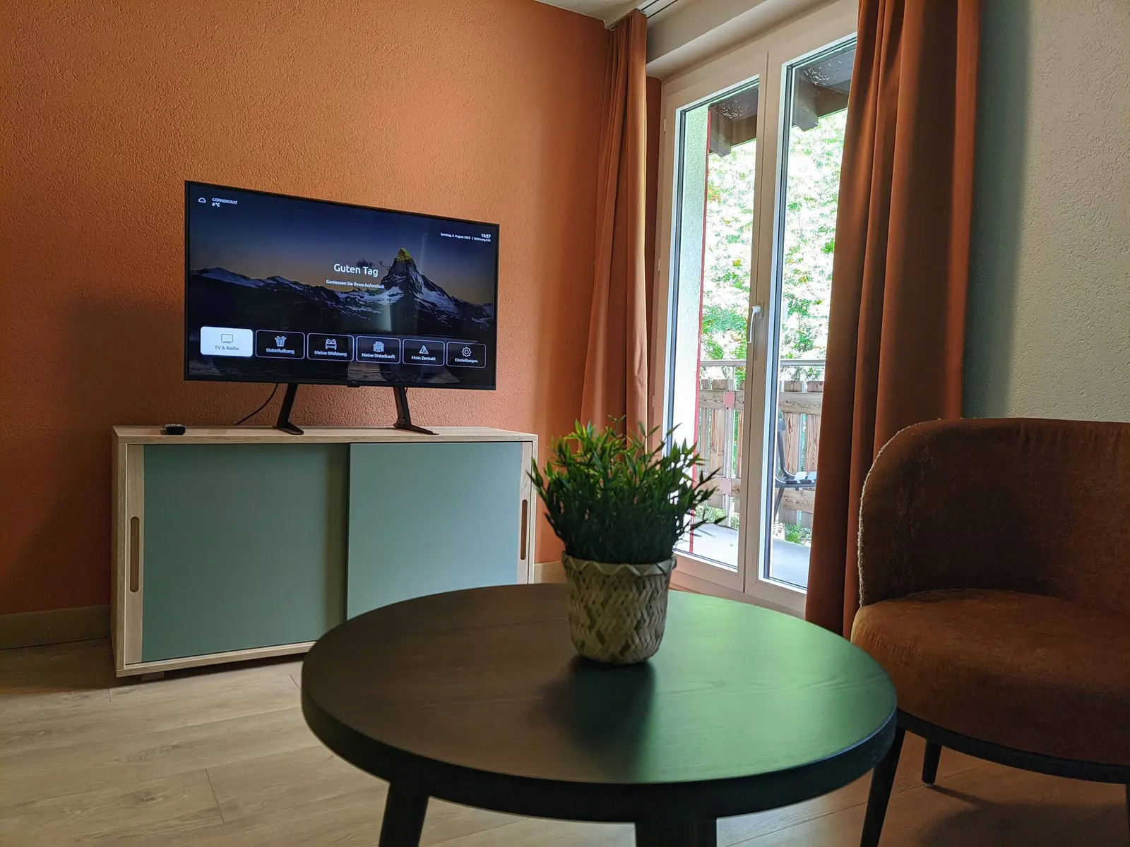 Living room with smart TV and balcony access