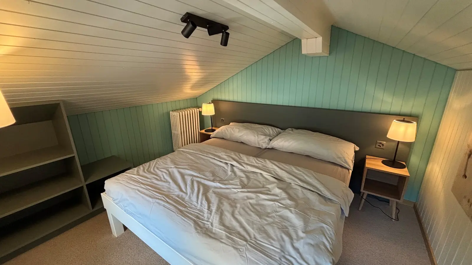 Attic bedroom with reading lamps